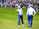 Jamie Donaldson (L) and Lee Westwood of Europe line up a putt on the 1st hole during the Afternoon Foursomes of the 2014 Ryder Cup on the PGA Centenary course at Gleneagles on September 27, 2014