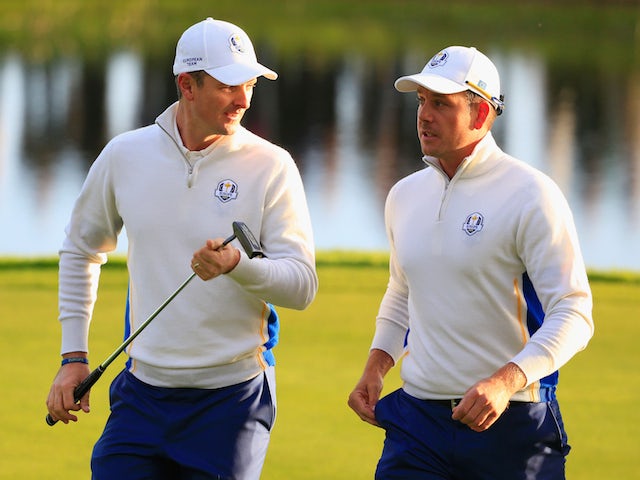 Justin Rose (L) and Henrik Stenson of Europe talk on the 2nd green during the Morning Fourballs of the 2014 Ryder Cup on the PGA Centenary course at Gleneagles on September 27, 2014