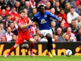 Romelu Lukaku of Everton holds off the challenges from Alberto Moreno of Liverpool during the Barclays Premier League match between Liverpool and Everton at Anfield on September 27, 2014