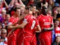 Steven Gerrard #8 of Liverpool is congratulated by teammates after scoring the opening goal from a free kick during the Barclays Premier League match between Liverpool and Everton at Anfield on September 27, 2014