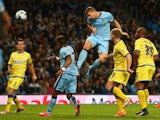 Edin Dzeko of Manchester City scores his sides fifth goal during the Capital One Cup Third Round match between Manchester City and Sheffield Wednesday at the Etihad Stadium on September 24, 2014