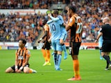 Edin Dzeko of Manchester City celebrates with team-mate David Silva after scoring his team's second goal during the Barclays Premier League match between Hull City and Manchester City at KC Stadium on September 27, 2014