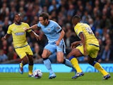 Frank Lampard of Manchester City beats Kamil Zayatte of Sheffield Wednesday during the Capital One Cup Third Round match between Manchester City and Sheffield Wednesday at Etihad Stadium on September 24, 2014