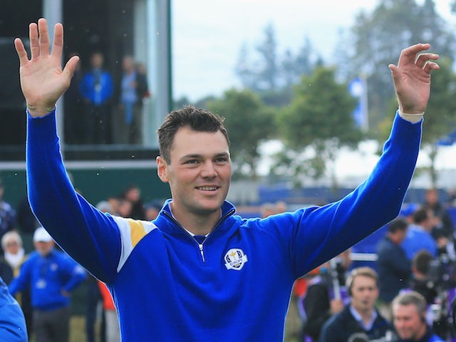 Martin Kaymer of Europe waves to the crowd on the 1st tee during the Singles Matches of the 2014 Ryder Cup on the PGA Centenary course at Gleneagles on September 28, 2014