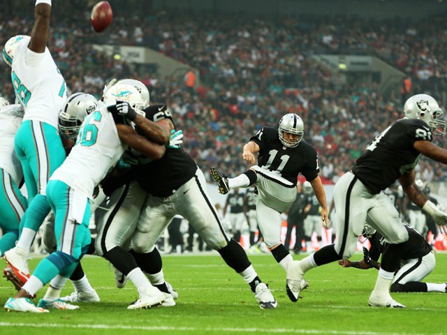 Sebastian Janikowski #11 of the Oakland Raiders adds the extra point to the touchdown scored by teammate Brian Leonhardt #87 of the Oakland Raiders during the NFL match between the Oakland Raiders and the Miami Dolphins at Wembley Stadium on September 28,