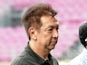 Singapore's billionaire Peter Lim walks on the pitch during an Atletico Madrid football clinic session for school children in Singapore on May 21, 2013