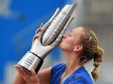 Petra Kvitova of the Czech Republic kisses the trophy after her win over Eugenie Bouchard of Canada in the final of the Wuhan Open tennis tournament in Wuhan, in China's Hubei province on September 27, 2014.