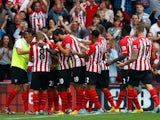Ryan Bertrand (#21) of Southampton celebrates with his team-mates after scoring the opening goal during the Barclays Premier League match between Southampton and Queens Park Rangers at St Mary's Stadium on September 27, 2014