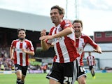 Tommy Smith of Brentford celebrates scoring Brentford's first goal during the Sky Bet Championship match between Brentford and Charlton Athletic at Griffin Park on August 9, 2014