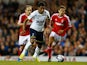 Paulinho of Tottenham Hotspur moves away from Jorge Grant of Nottingham Forest during the Capital One Cup third round match between Tottenham Hotspur and Nottingham Forest at White Hart Lane on September 24, 2014