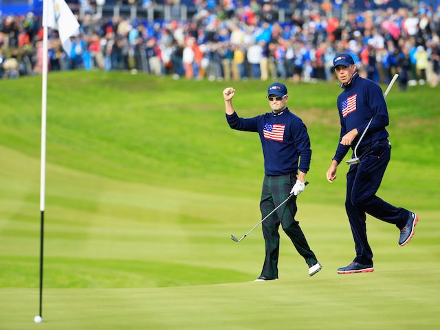 Zach Johnson (L) of the United States celebrates chipping in on the 1st hole with Matt Kuchar during the Afternoon Foursomes of the 2014 Ryder Cup on the PGA Centenary course at Gleneagles on September 27, 2014