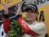 Theodore Racing by Prema's Alex Lynn of Britain celebrates on the podium after winning the Formula Three Macau Grand Prix on November 17, 2013