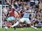 West Ham United's Cameroonian midfielder Alex Song (L) vies with Queens Park Rangers' Brazilian midfielder Sandro (R) during the English Premier League football match 
