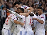 Lyon's French forward Alexandre Lacazette is congratulated by his teammates after scoring a goal during a French L1 football match between Lyon (OL) and Lille (LOSC) on October 5, 2014