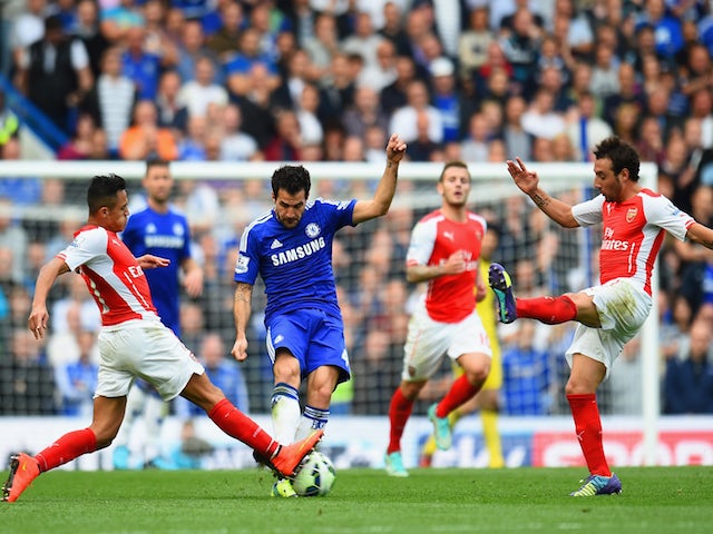 Cesc Fabregas of Chelsea is closed down by Alexis Sanchez and Santi Cazorla of Arsenal during the Barclays Premier League match on October 5, 2014