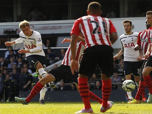 Tottenham Hotspur's Danish midfielder Christian Eriksen (L) scores the opening goal of the English Premier League football match between Tottenham Hotspur and Southampton on October 5, 2014