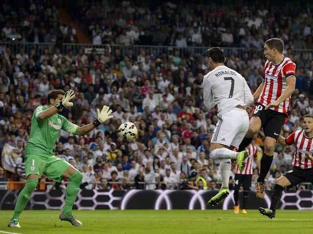 Real Madrid's Portuguese forward Cristiano Ronaldo heads to score during the Spanish league football match Real Madrid vs Athletic Club Bilbao at the Santiago Bernabeu stadium in Madrid on October 5, 2014