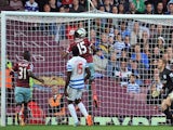 West Ham United's Senegalese striker Diafra Sakho scores their second goal as Queens Park Rangers' English goalkeeper Robert Green (R) looks on during the English Premier League football match on October 5, 2014
