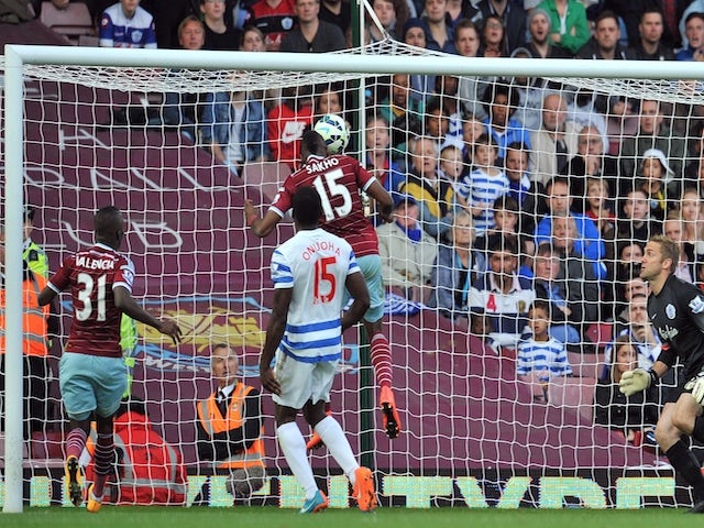 West Ham United's Senegalese striker Diafra Sakho scores their second goal as Queens Park Rangers' English goalkeeper Robert Green (R) looks on during the English Premier League football match on October 5, 2014