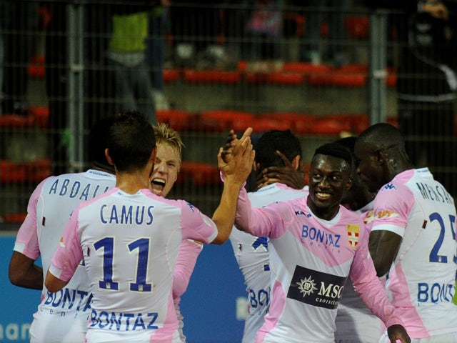 Evian team members celebrate after scoring a goal during their French L1 football match Evian Thonon Gaillard against Metz (FC) on October 4, 2014