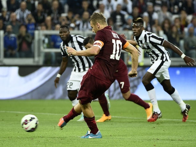 Roma's forward Francesco Totti scores a penalty kick during the Italian Serie A football match Juventus vs Roma on October 5, 2014