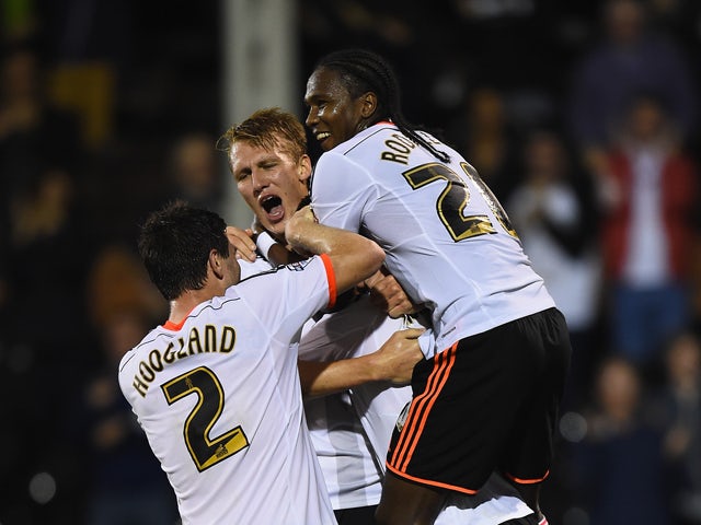 Fernando Amorebieta of Fulham is buried by team mates after scoring his team's second goal during the Sky Bet Championship match between Fulham and Bolton Wanderers at Craven Cottage on October 1, 2014