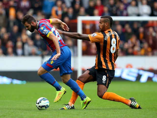 Joe Ledley of Crystal Palace battles for the ball with Tom Huddlestone of Hull City during the Barclays Premier League match between Hull City and Crystal Palace at KC Stadium on October 4, 2014