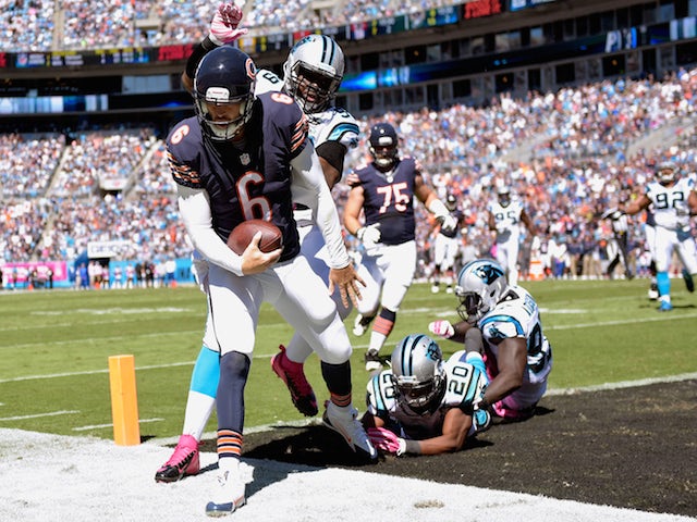 Jay Cutler #6 of the Chicago Bears beats Kawann Short #99 of the Carolina Panthers to the pylon for a touchdown during the first quarter of their game on October 5, 2014