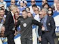 Chelsea's Portuguese manager Jose Mourinho (R) and Arsenal's French manager Arsene Wenger (L) are kept apart by the fourth official Jonathan Moss during the English Premier League match on October 5, 2014