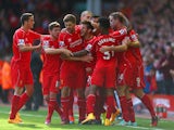 Adam Lallana of Liverpool is congratulated by team mates on scoring the opening goal during the Barclays Premier League match between Liverpool and West Bromwich Albion at Anfield on October 4, 2014