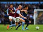 David Silva of Manchester City runs with the ball past Philippe Senderos of Aston Villa during the Barclays Premier League match between Aston Villa and Manchester City at Villa Park on October 4, 2014