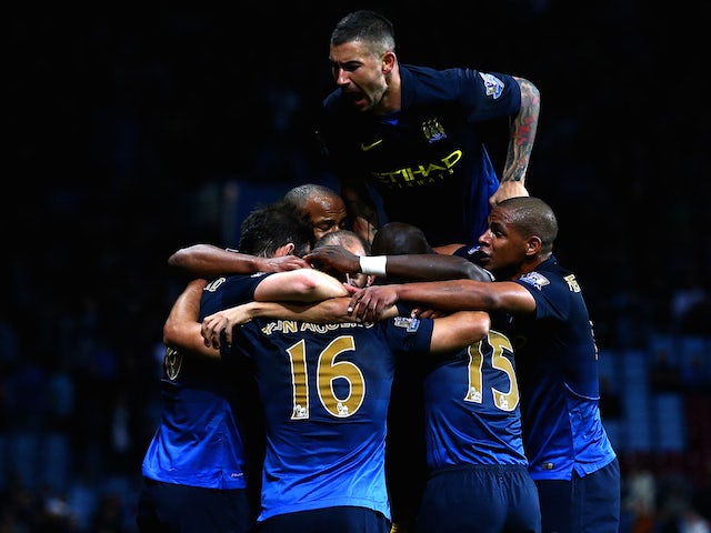 Sergio Aguero of Manchester City celebrates with teammates after scoring their second goal during the Barclays Premier League match against Aston Villa at Villa Park on October 4, 2014
