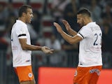 Montpellier's Brazilian defender Vitorino Hilton celebrates with Moroccan defender Abdelhamid El Kaoutari after scoring a goal during the French L1 football match between Nice and Montpellier at the Allianz Riviera stadium in Nice, southeastern France, on