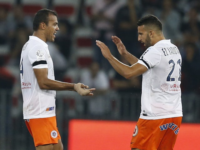 Montpellier's Brazilian defender Vitorino Hilton celebrates with Moroccan defender Abdelhamid El Kaoutari after scoring a goal during the French L1 football match between Nice and Montpellier at the Allianz Riviera stadium in Nice, southeastern France, on