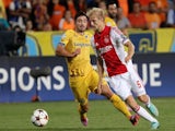 Ajax Amsterdam's Nicolai Boilesen (R) fights for the ball against APOEL Nicosia's Tiago Gomes during their group F UEFA Champions League football match on September 30, 2014