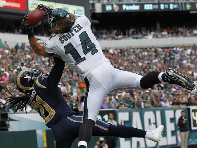 Wide receiver Riley Cooper #14 of the Philadelphia Eagles catches a touchdown pass in the second quarter with defensive back Janoris Jenkins #21 of the St. Louis Rams on October 5, 2014