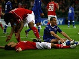 Everton's Philip Jagielka sits on the pitch whilst Standard Liege players celebrate during the UEFA Cup first round, second leg match, between Standard Liege and Everton at Stade Maurice Dufrasne, on October 2, 2008