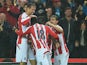Peter Crouch of Stoke City celebrates with team-mates after scoring the opening goal during the Barclays Premier League match between Stoke City and Newcastle United at Britannia Stadium on September 29, 2014