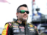 Tony Stewart, driver of the #14 Rush Truck Centers/Mobil 1 Chevrolet, walks in the garage area during practice for the NASCAR Sprint Cup Series Hollywood Casino 400 at Kansas Speedway on October 3, 2014