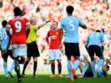 Wayne Rooney of Manchester United receives a straight red card by referee Lee Mason after a foul on Stewart Downing of West Ham during the Barclays Premier League match between Manchester United and West Ham United at Old Trafford on September 27, 2014