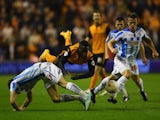Nouha Dicko of Wolverhampton Wanderers is challenged by Jack Robinson and Jonathan Hogg of Huddersfield Town during the Sky Bet Championship match between Wolverhampton Wanderers and Huddersfield Town at Molineux on October 1, 2014