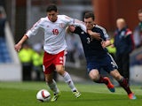 Andrew Robertson of Scotland battles for the ball with Giorgi Papava of Georgia during the EURO 2016 Qualifier match on October 11, 2014