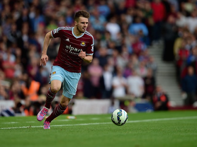 Carl Jenkinson of West Ham United in action during the Barclays Premier League match between West Ham United and Queens Park Rangers at Boleyn Ground on October 5, 2014