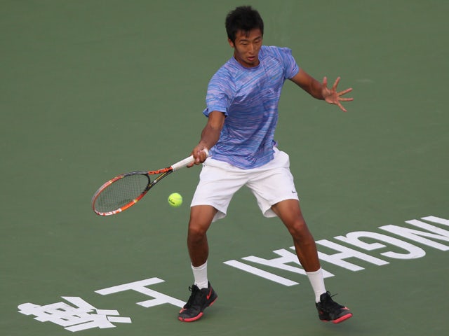 Chuhan Wang of China returns a shot during his match against Fabio Fognini of Italy during the day 3 of the Shanghai Rolex Masters at the Qi Zhong Tennis Center on October 7, 2014