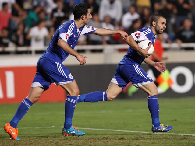 Cyprus' Konstantinos Makridis celebrates scoring against Israel during their Euro 2016 qualifying football match at the GSP Stadium in Nicosia on October 10, 2014