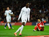Danny Welbeck of England celebrates scoring their third goal as goalkeeper Aldo Simoncini of San Marino looks dejected during the EURO 2016 Group E Qualifying match on October 9, 2014