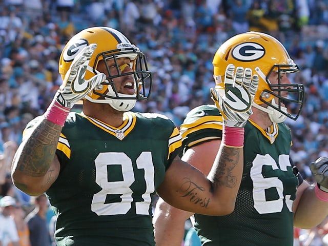 Tight end Andrew Quarless #81 of the Green Bay Packers celebrates his game-winning touchdown catch against the Miami Dolphins in the fourth quarter during a game at Sun Life Stadium on October 12, 2014