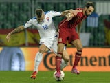 Juanfran (R) of Spain vies for a ball with Juraj Kucka of Slovakia during Euro 2016 qualifing football match between Slovakia and Spain in northern Slovak town of Zilina on October 9, 2014