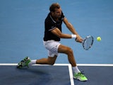Julien Benneteau of France returns a shot to Kei Nishikori of Japan in the mens single finals during the Malaysian Open at Putra Stadium on September 28, 2014