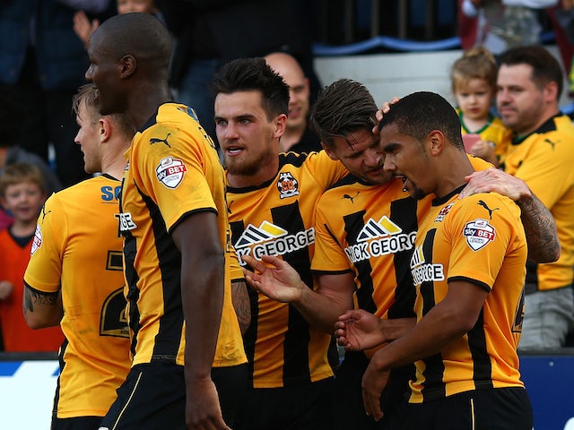 Kwesi Appiah of Cambridge celebrates with team mates after scoring his and the teams second goal of the game during the Sky Bet League Two match against Oxford United on October 11, 2014